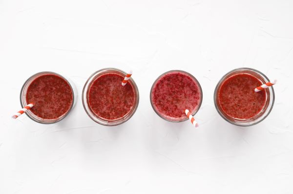 Four smoothie glasses as seen from above.