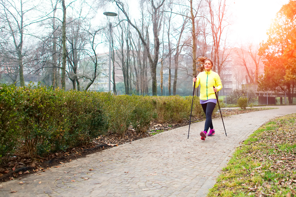 Girl make Nordic walking in the park in the city
