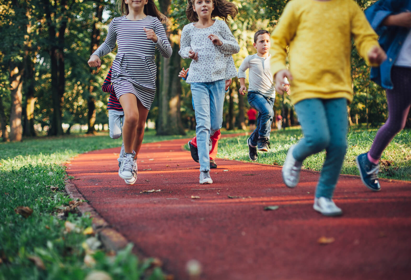 young children running along a track