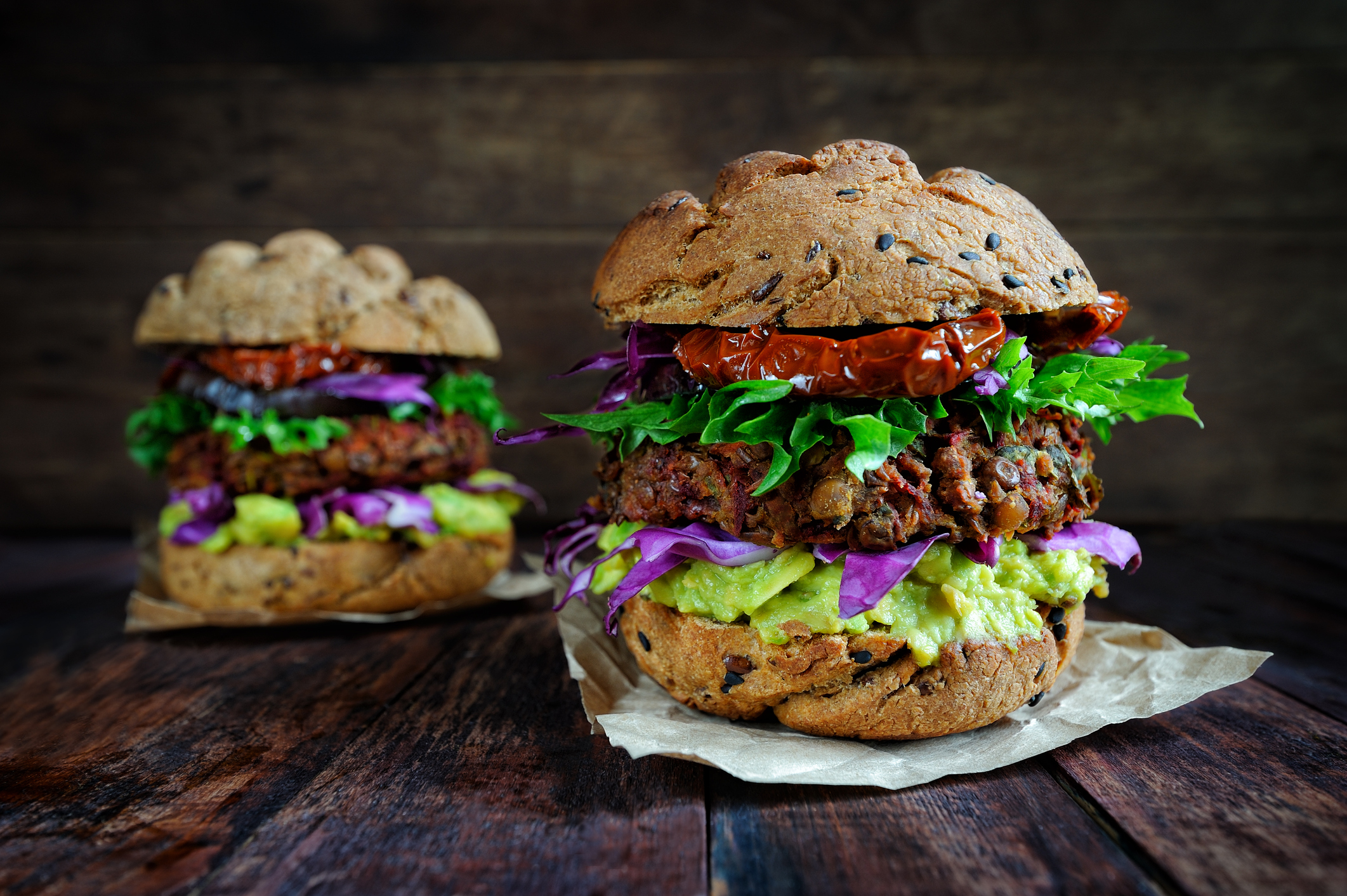 Fresh beetroot lentil vegan burger with grilled eggplant, sun-dried tomatoes and guacamole sauce