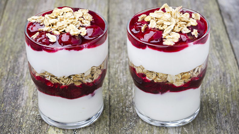 layered dessert with yogurt, cherries and granola
