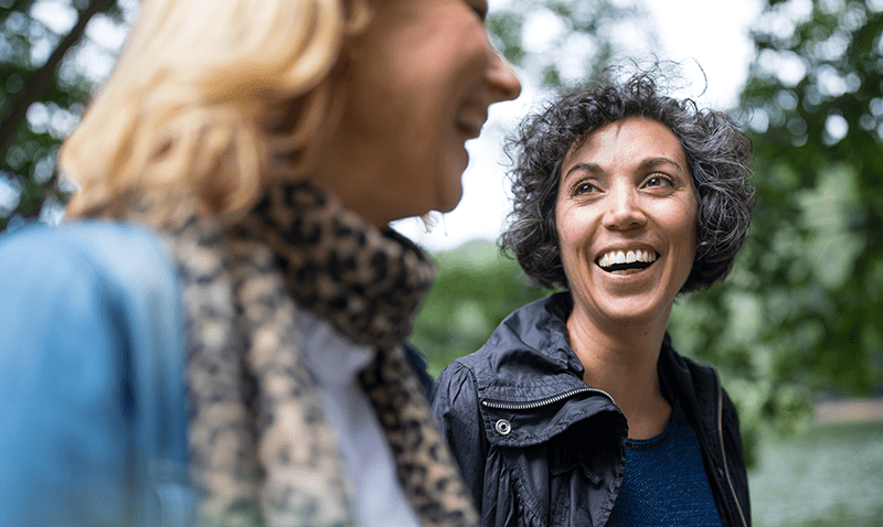 Two women smiling outside