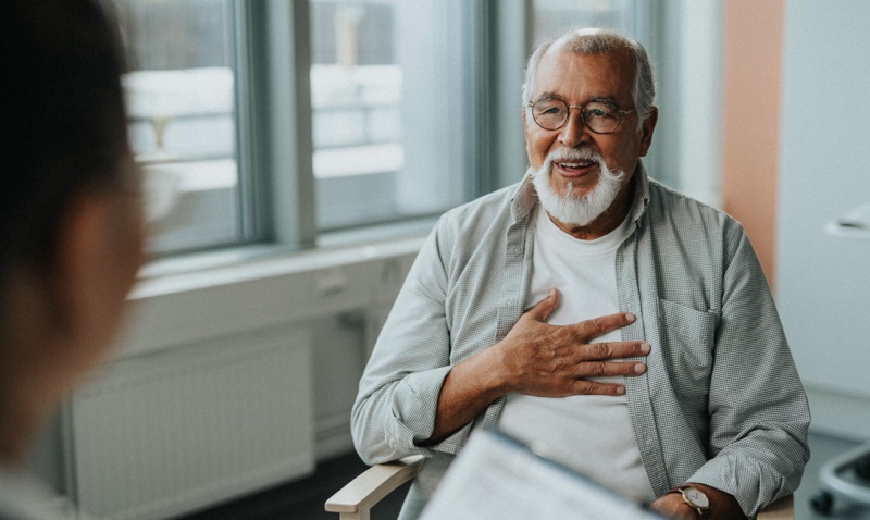 Man with glasses speaking to someone