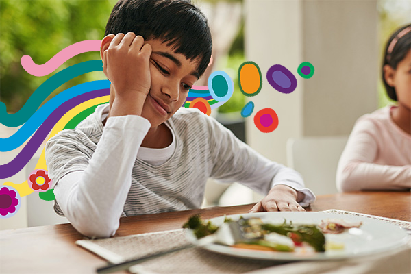 Boy at dinner table looking sad
