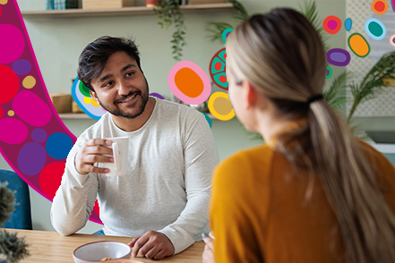 man talking to woman over coffee