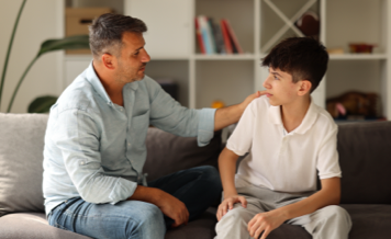 Man sitting on couch with son