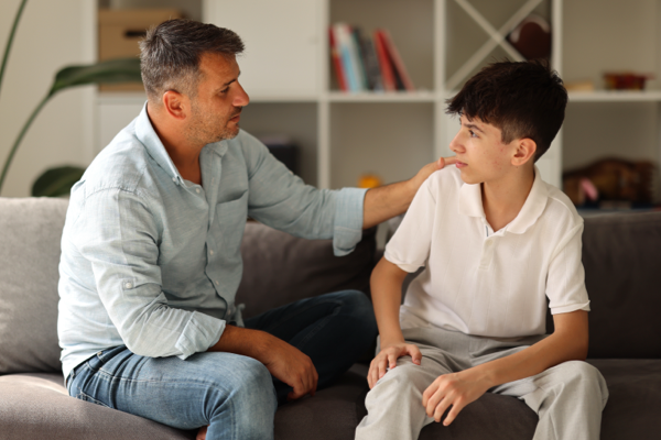 Man sitting on couch with son