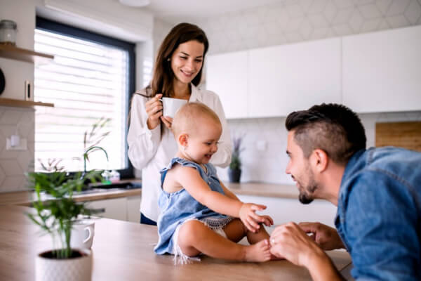 A mum applying face cream on her kid in bathroom