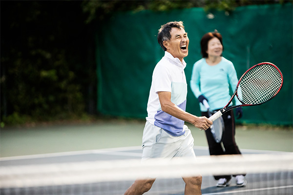 couple playing tennis. Exercise is a great way to help in the prevention of osteoarthritis