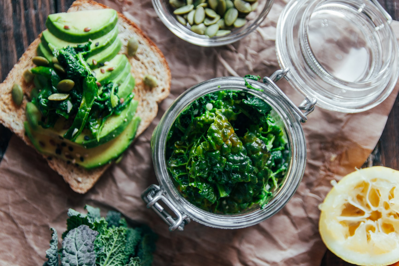 Healthy food spread of avocado on toast and leafy greens