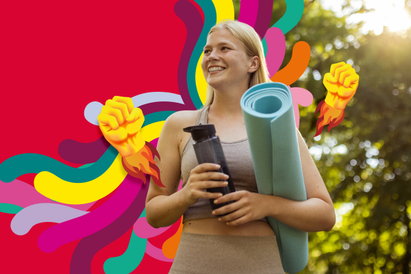 Woman smiling holding a yoga mat