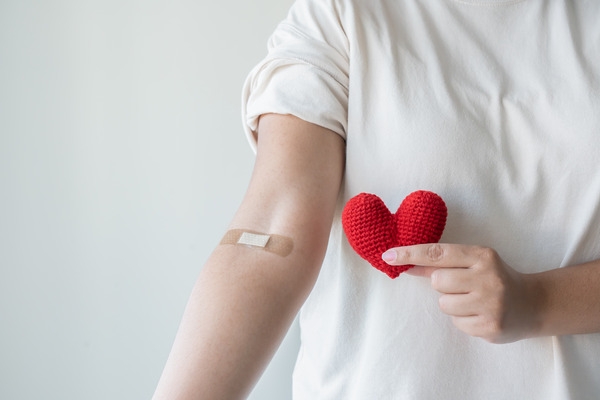 Blood donor with a plaster on his inside elblow