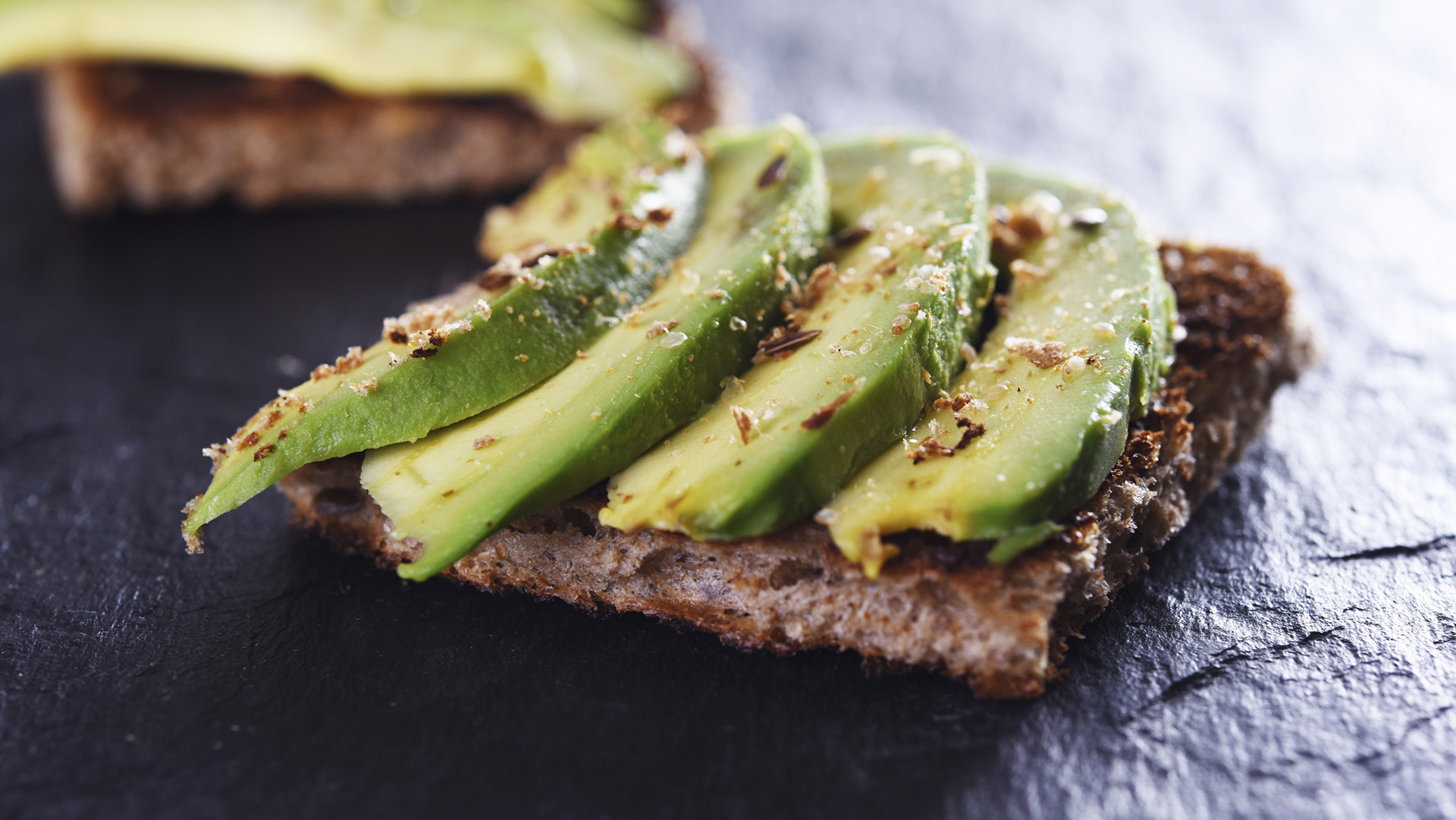 sliced avocado on toast bread with spices