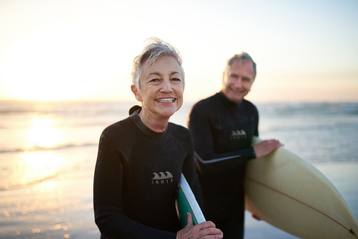 Cropped shot of a senior married couple coming from surfing