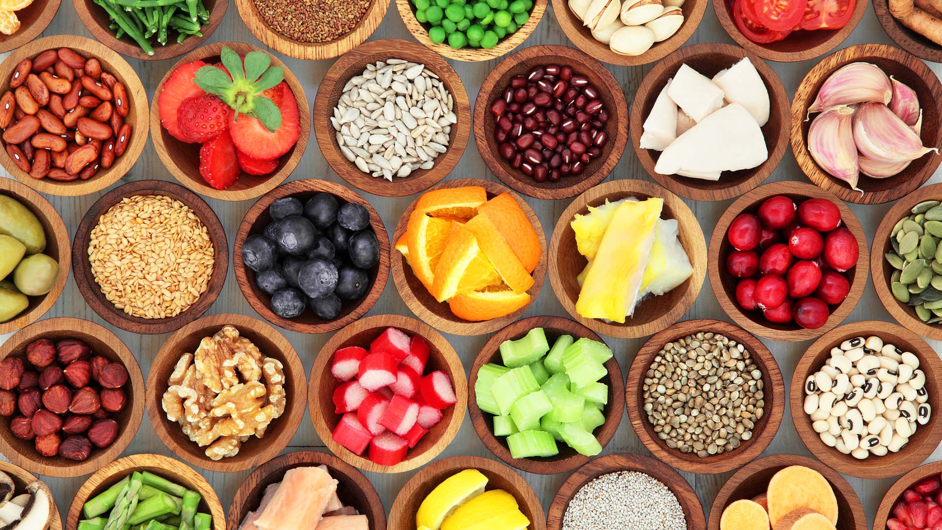 Super food diet selection in wooden bowls. High in antioxidants, vitamins, minerals and anthocyanins.