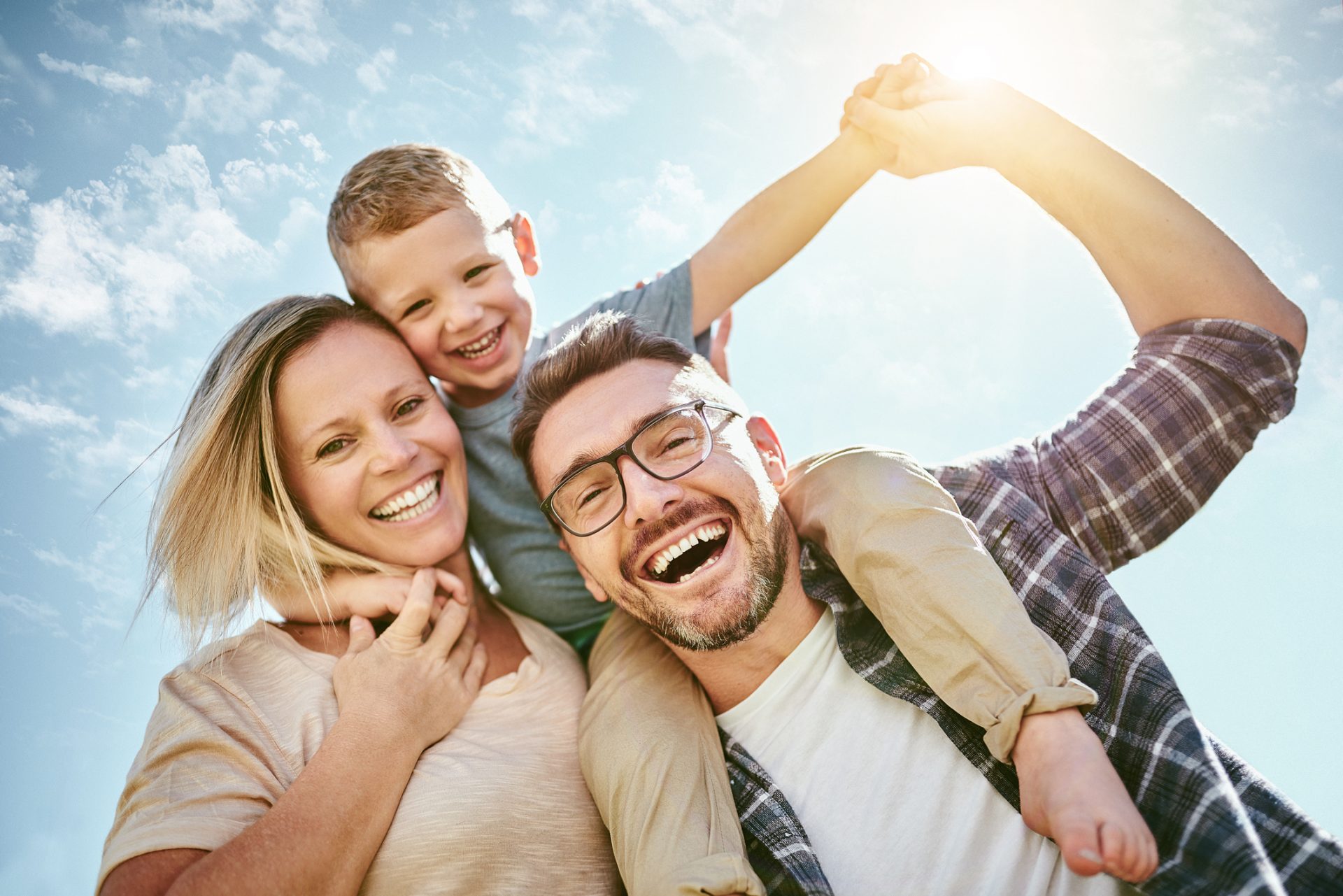 Portrait of a happy young family having fun outdoors