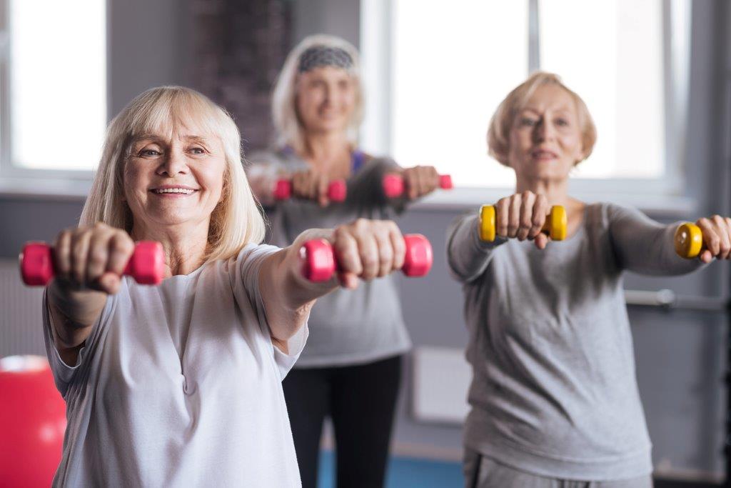 older women participating in a group fitness class. Exercise is helpful in osteoarthritis management