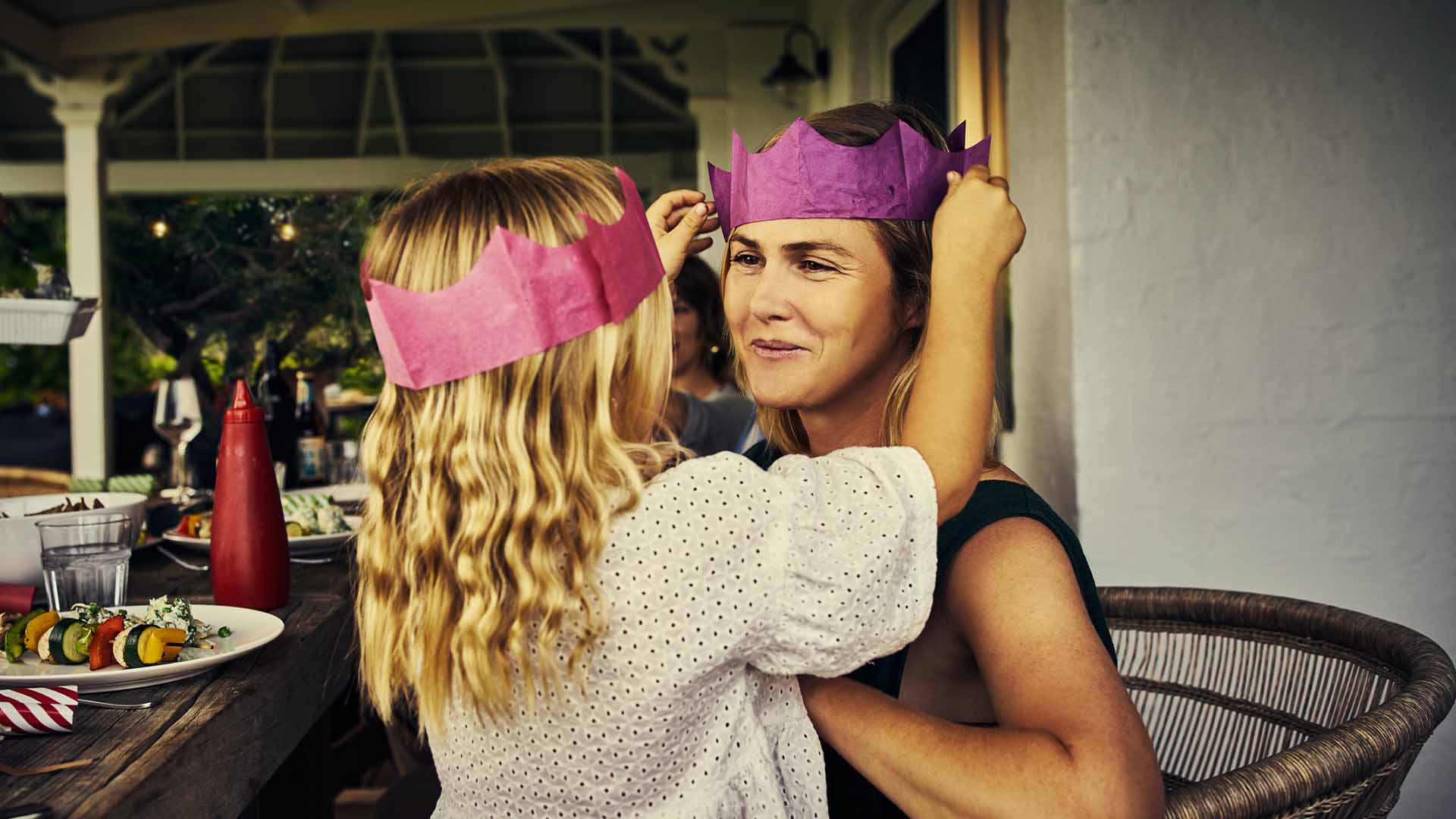 Shot of a little girl placing a paper crown on her mother's head