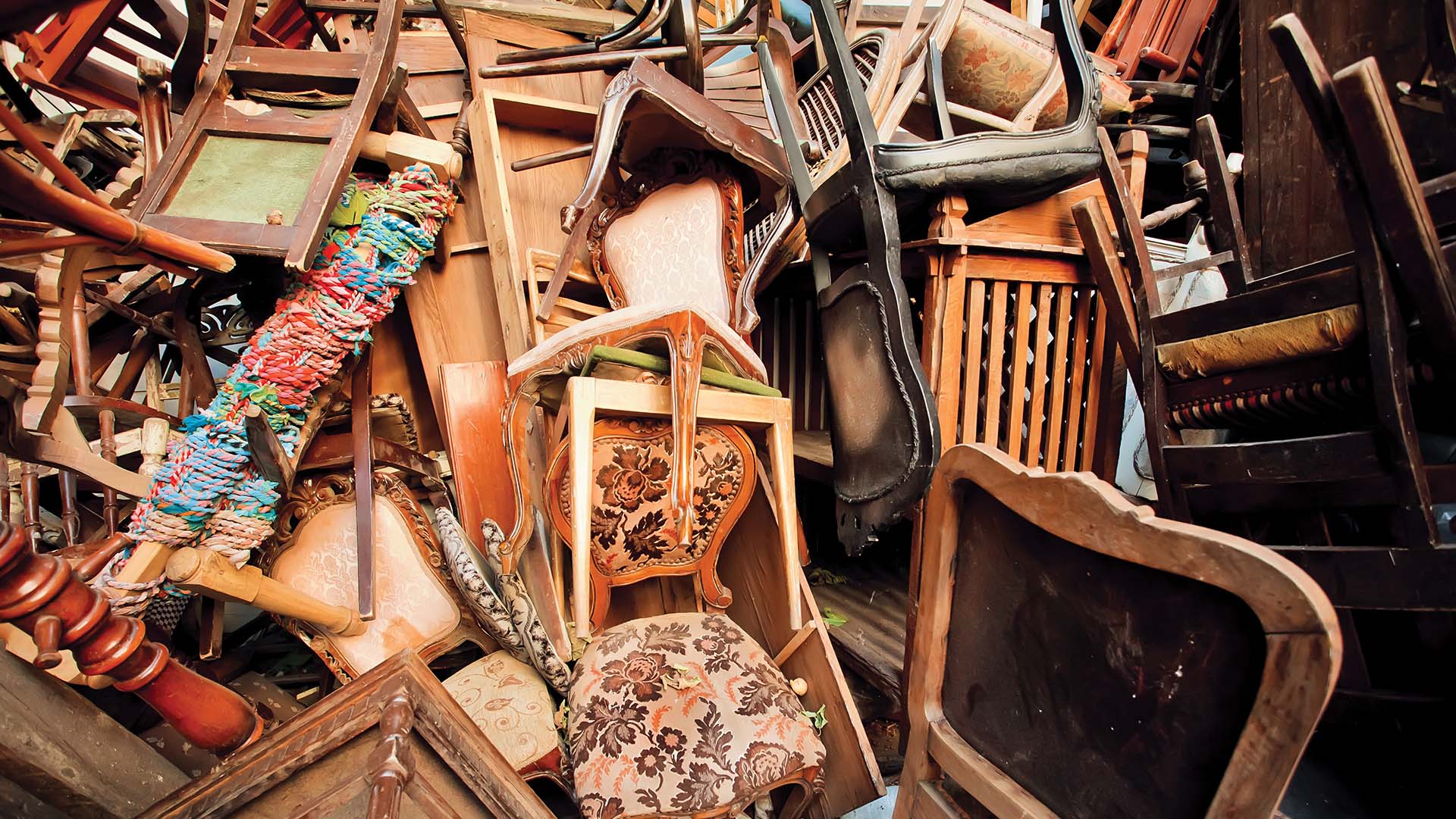 Dump old wooden chairs and vintage chairs, one on the other, thrown into the street