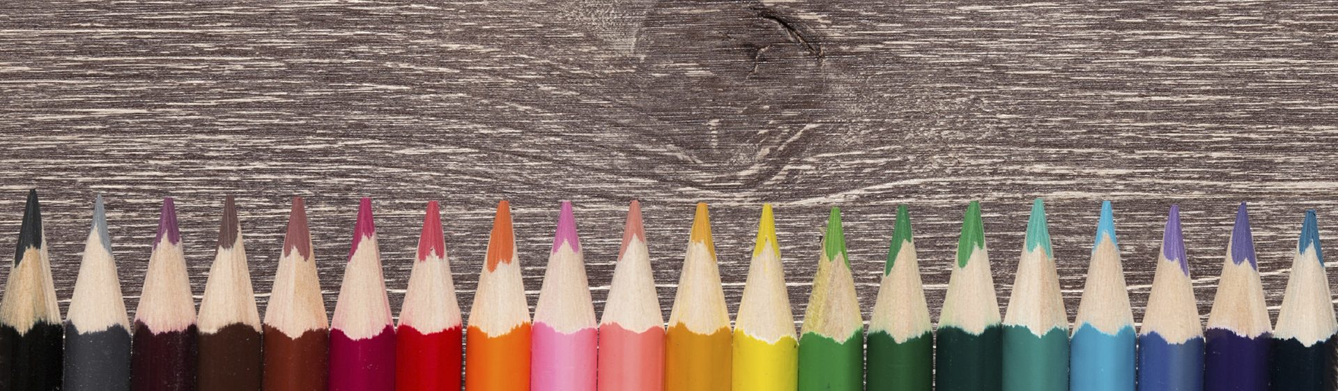 Close up of Colorful Pencils On Wooden Background. Shallow Depth of Field