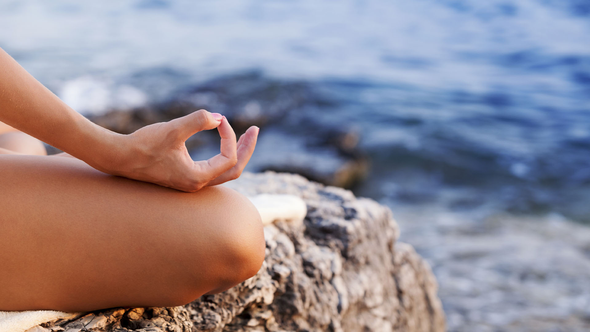 Woman doing yoga at sunset, lotus position, copy space