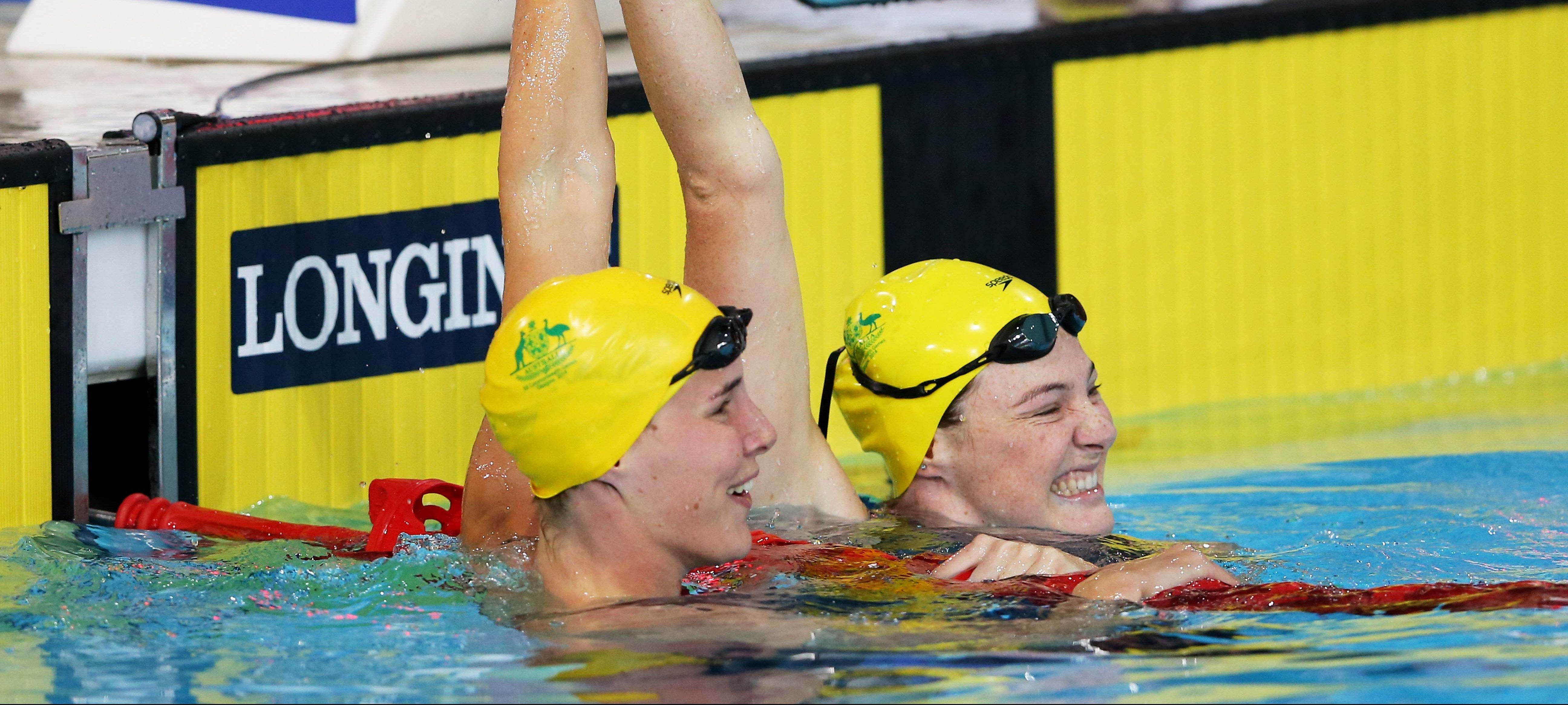 GLASGOW, SCOTLAND - JULY 28:  Cate Campbell (R) of Australia celebrates winning the gold medal with silver medallist Bronte Campbell of Australia after the Women's 100m Freestyle Final at Tollcross International Swimming Centre during day five of the Glasgow 2014 Commonwealth Games on July 28, 2014 in Glasgow, Scotland.  (Photo by Quinn Rooney/Getty Images)