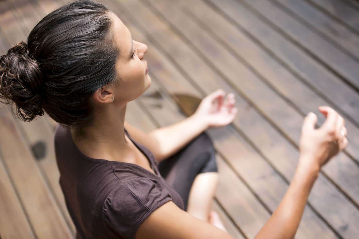 Elevated view of young woman meditating