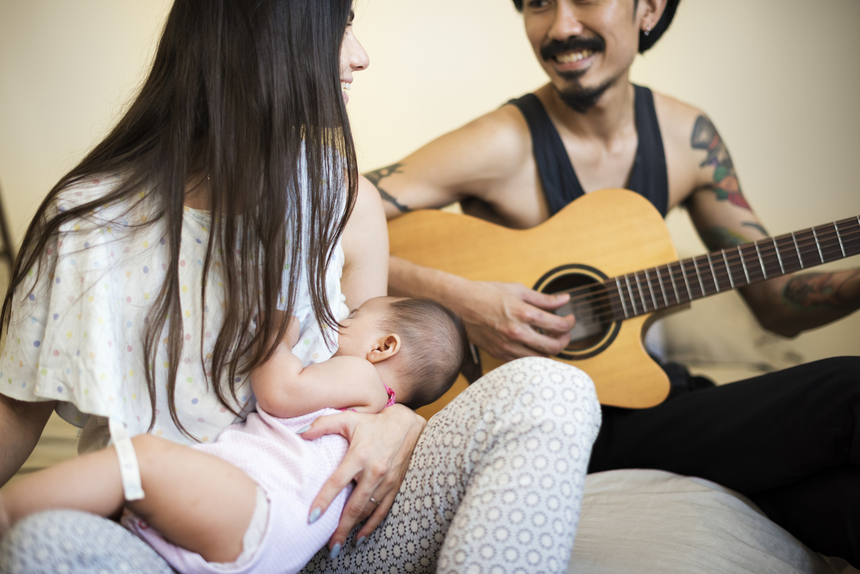 Father and mother are taking care of their child.