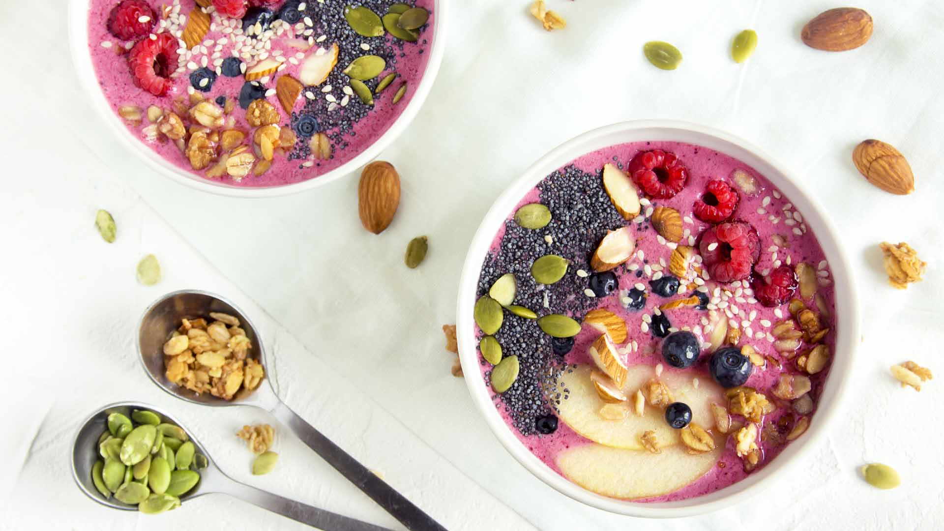 Smoothie bowl with fresh berries, nuts, seeds and homemade granola for healthy breakfast