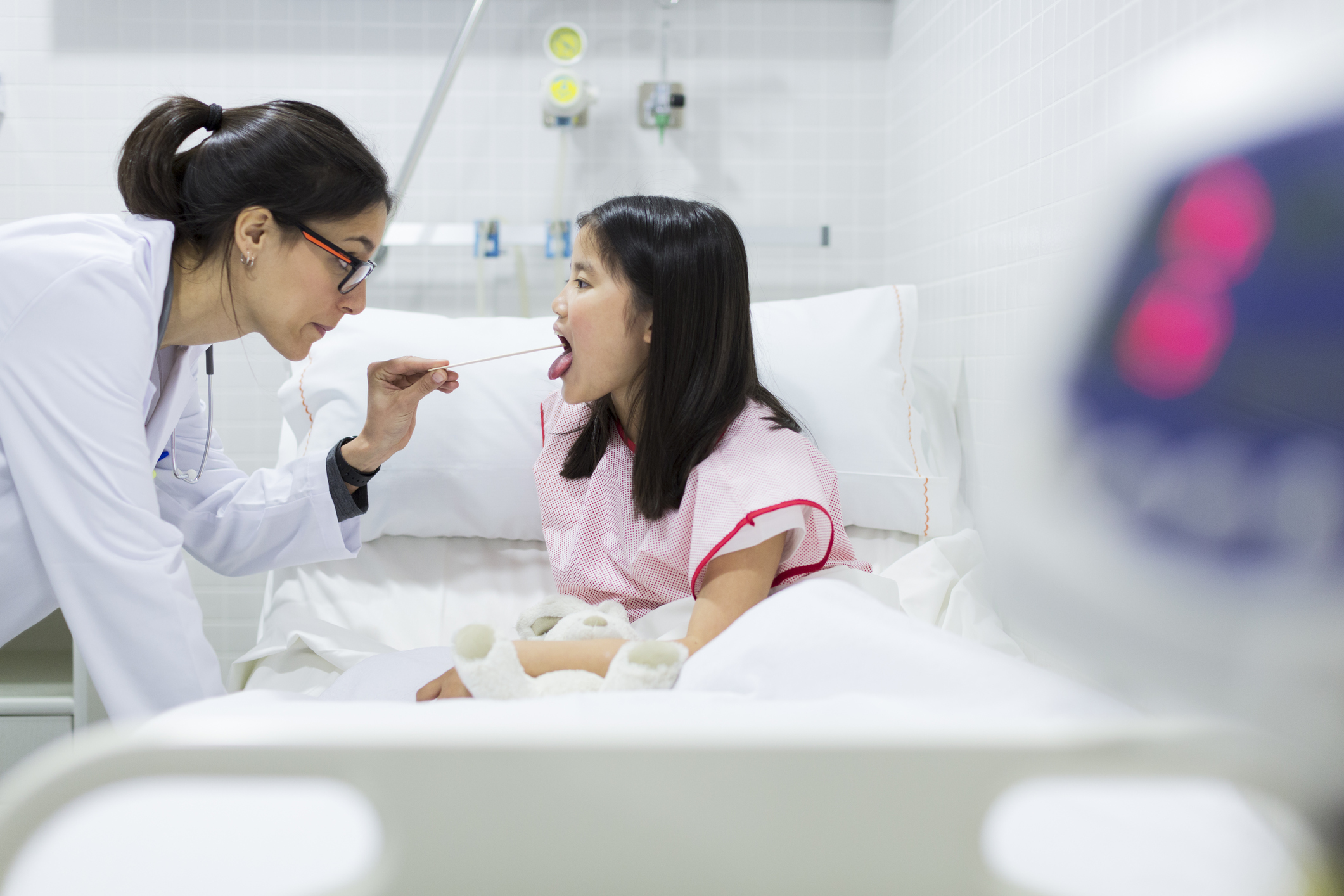 Doctor looking into child's mouth