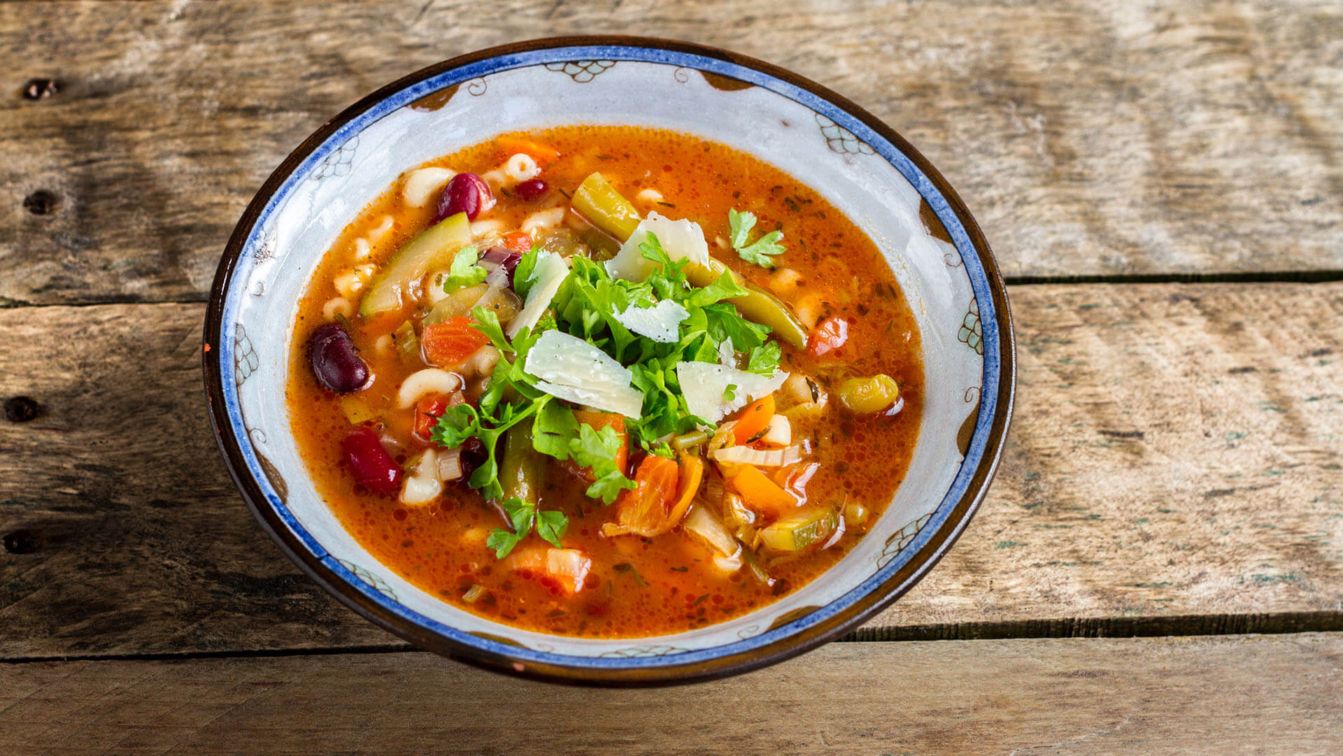 Minestrone soup - italian vegetable soup with pasta and parmesan cheese.