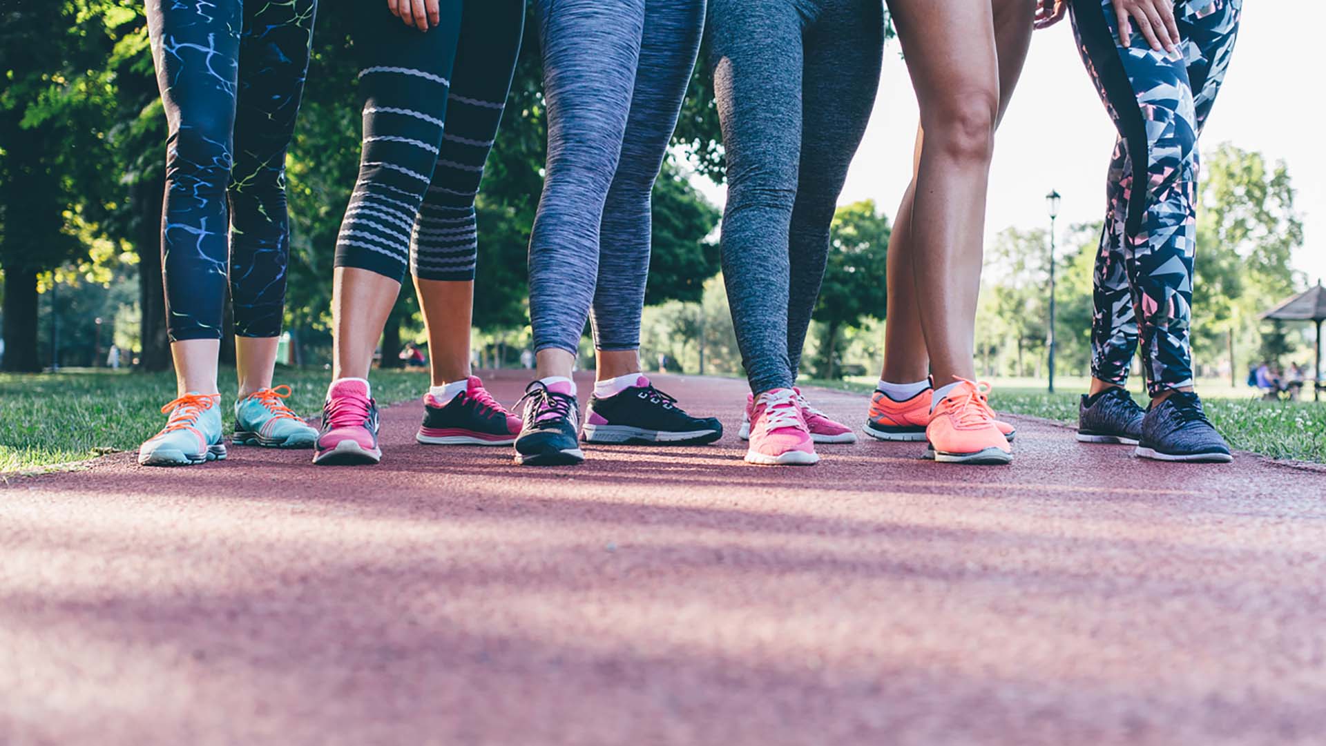 Fit young women preparing for race. Closeup of young athletes legs at start position with copy space.