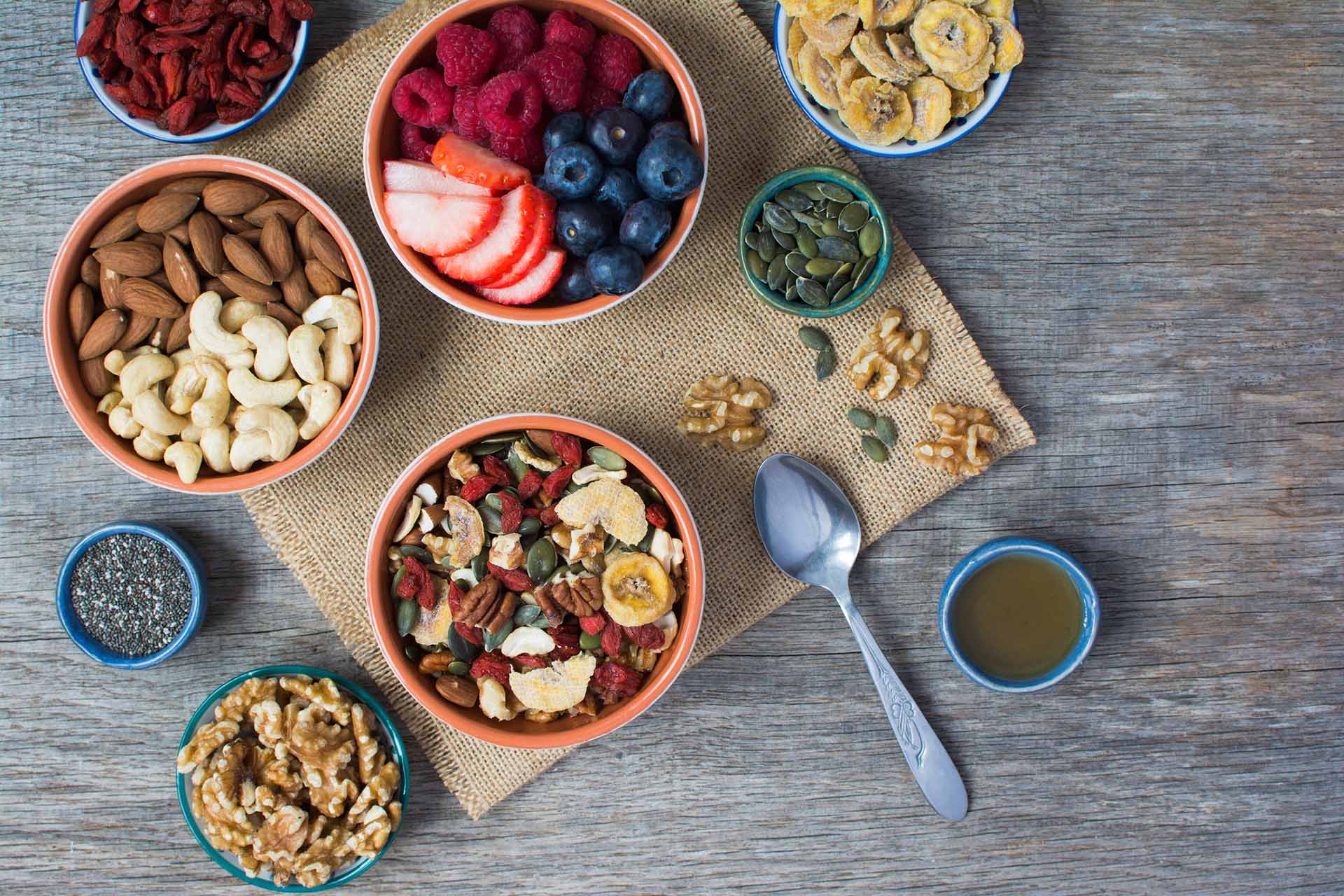 Paleo style breakfast: gluten free and oat free muesli made with nuts, dried berries and fruits, top view