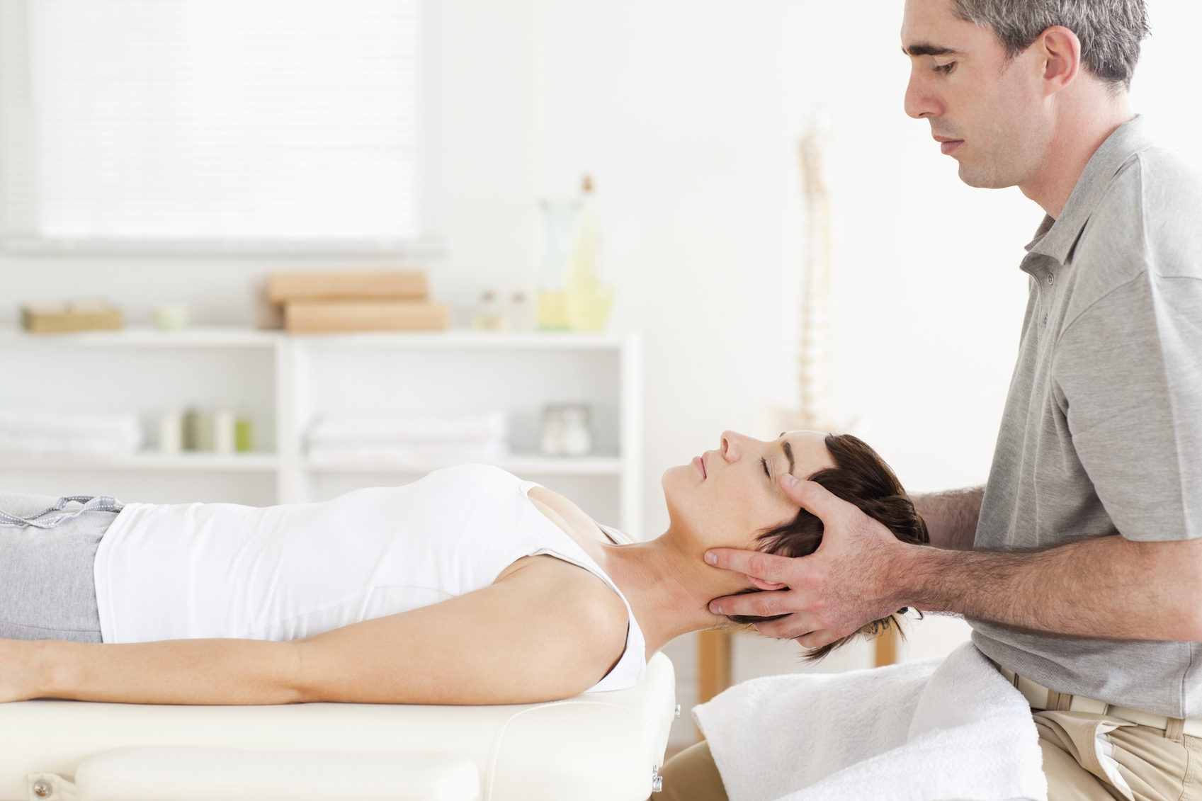 Man stretching a cute woman in a room