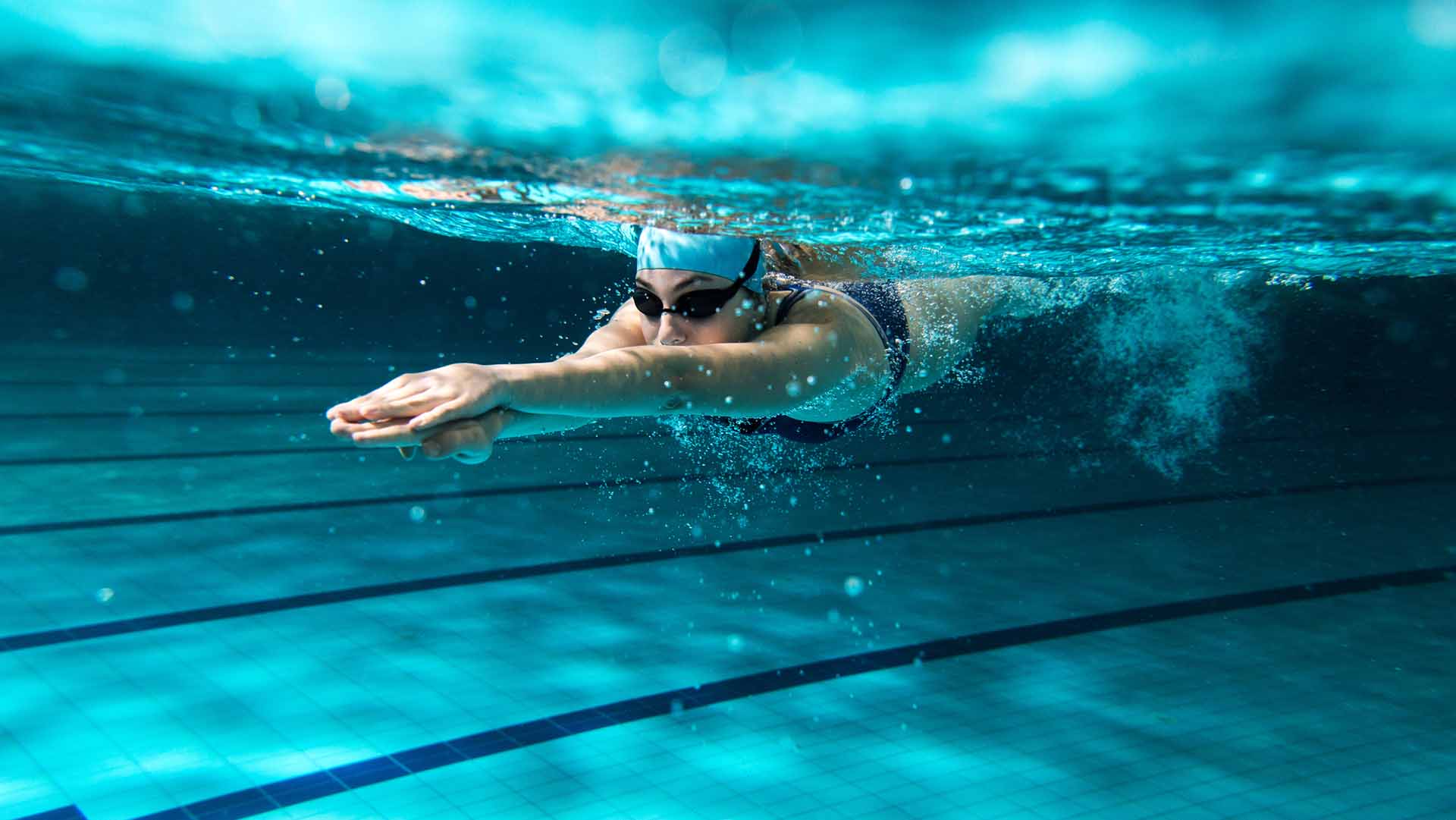 Female swimmer at the swimming pool.Underwater photo.