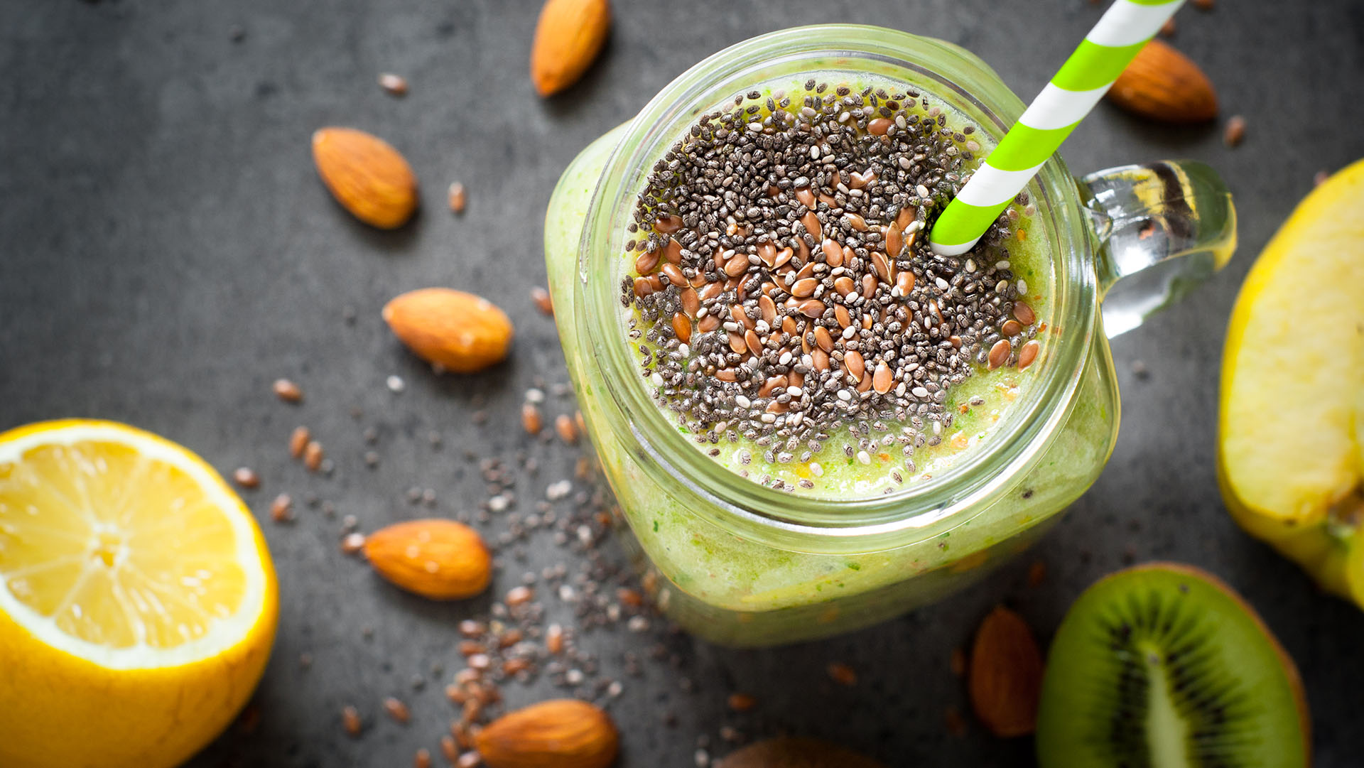 Green smoothie from fruit, leaves and seeds. A healthy eating and detox concept.