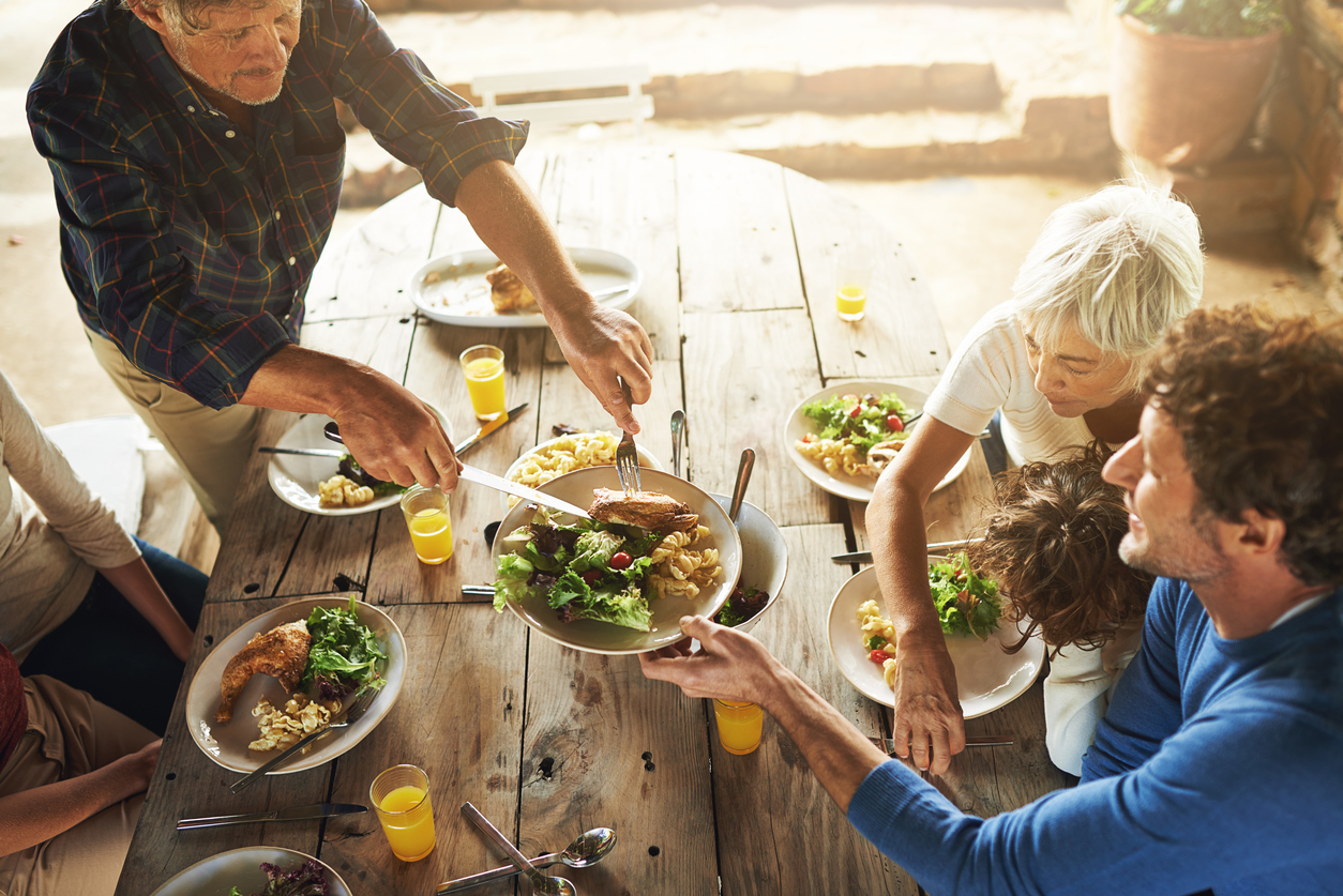 High angle shot of a family to eating lunch together outdoors