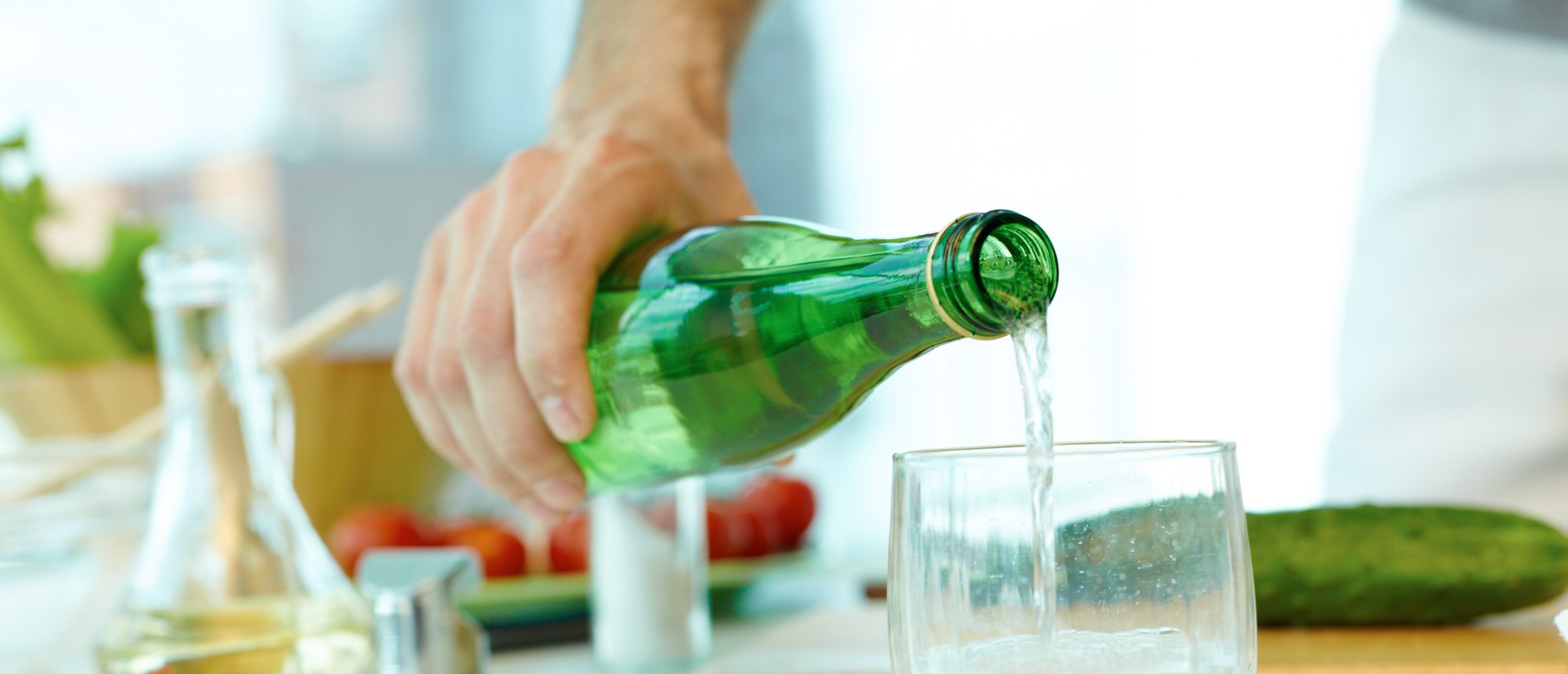 Man pouring mineral water in glass