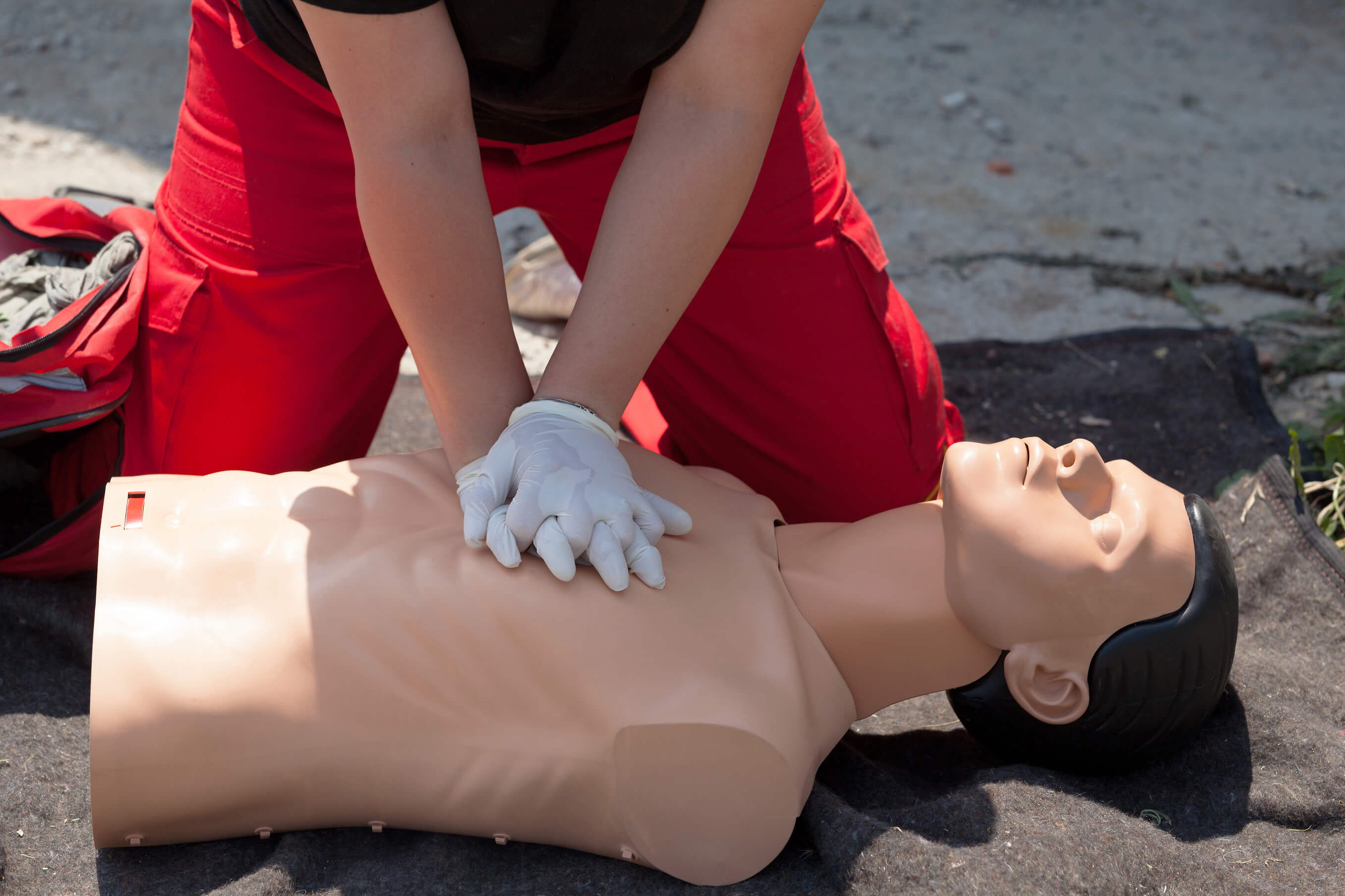 First aid training. CPR being performed on a medical-training manikin.