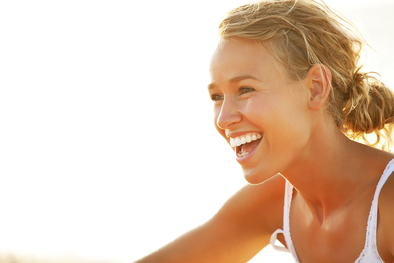 Close-up of a young woman smiling.