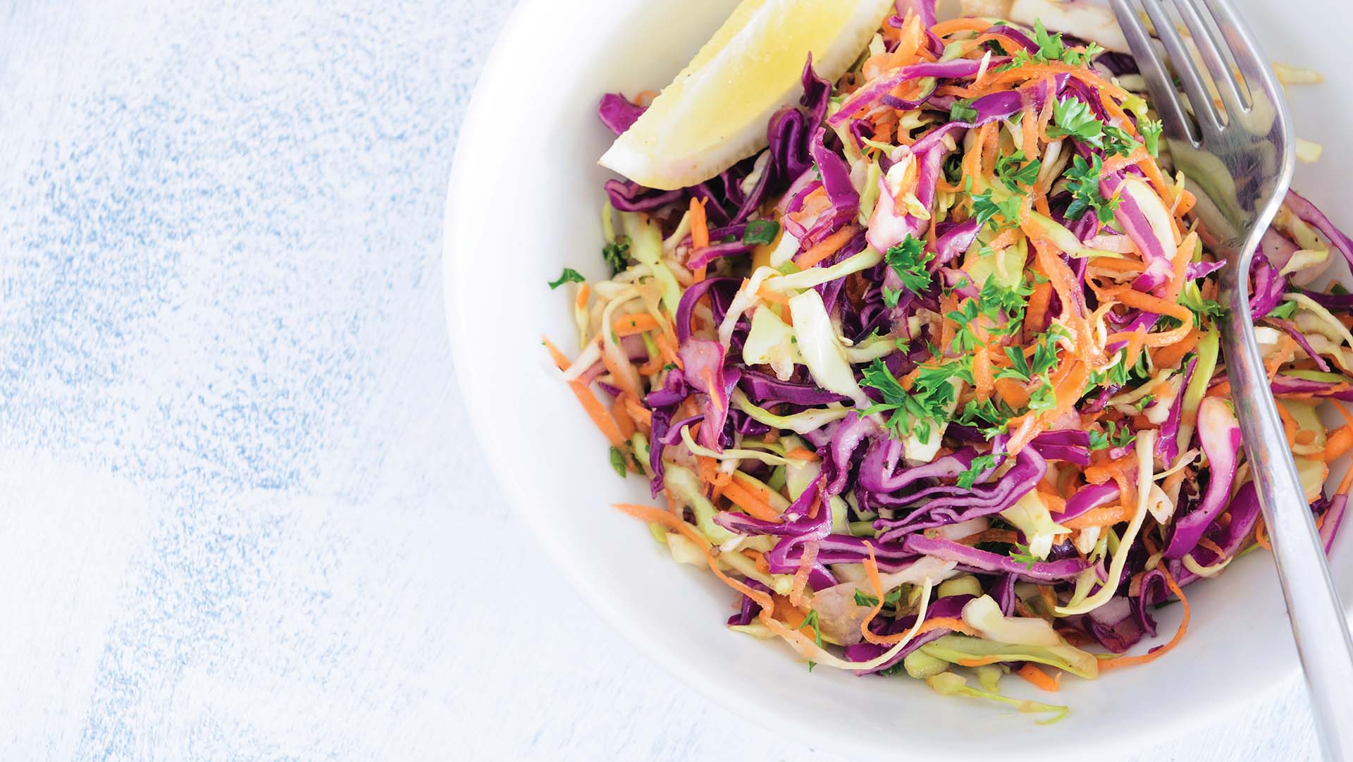 Serving of coleslaw a healthy vibrant colourful salad made with shredded raw cabbage, carrots and onions