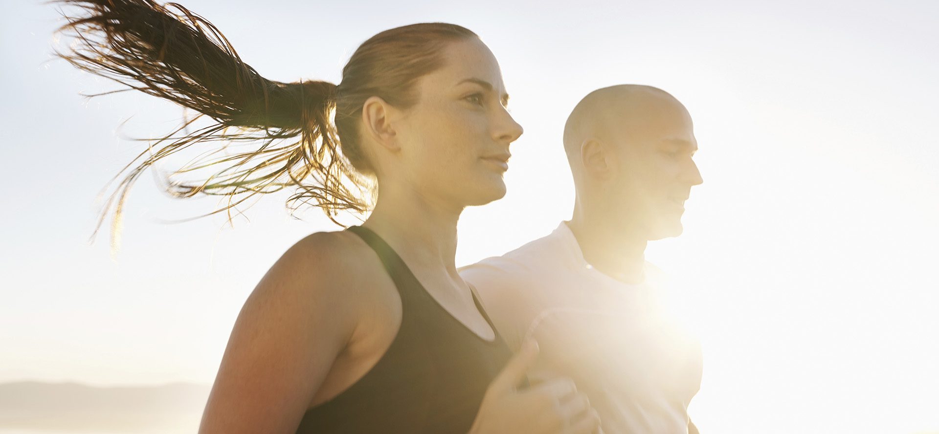 Cropped shot of a two young athletes running outdoors