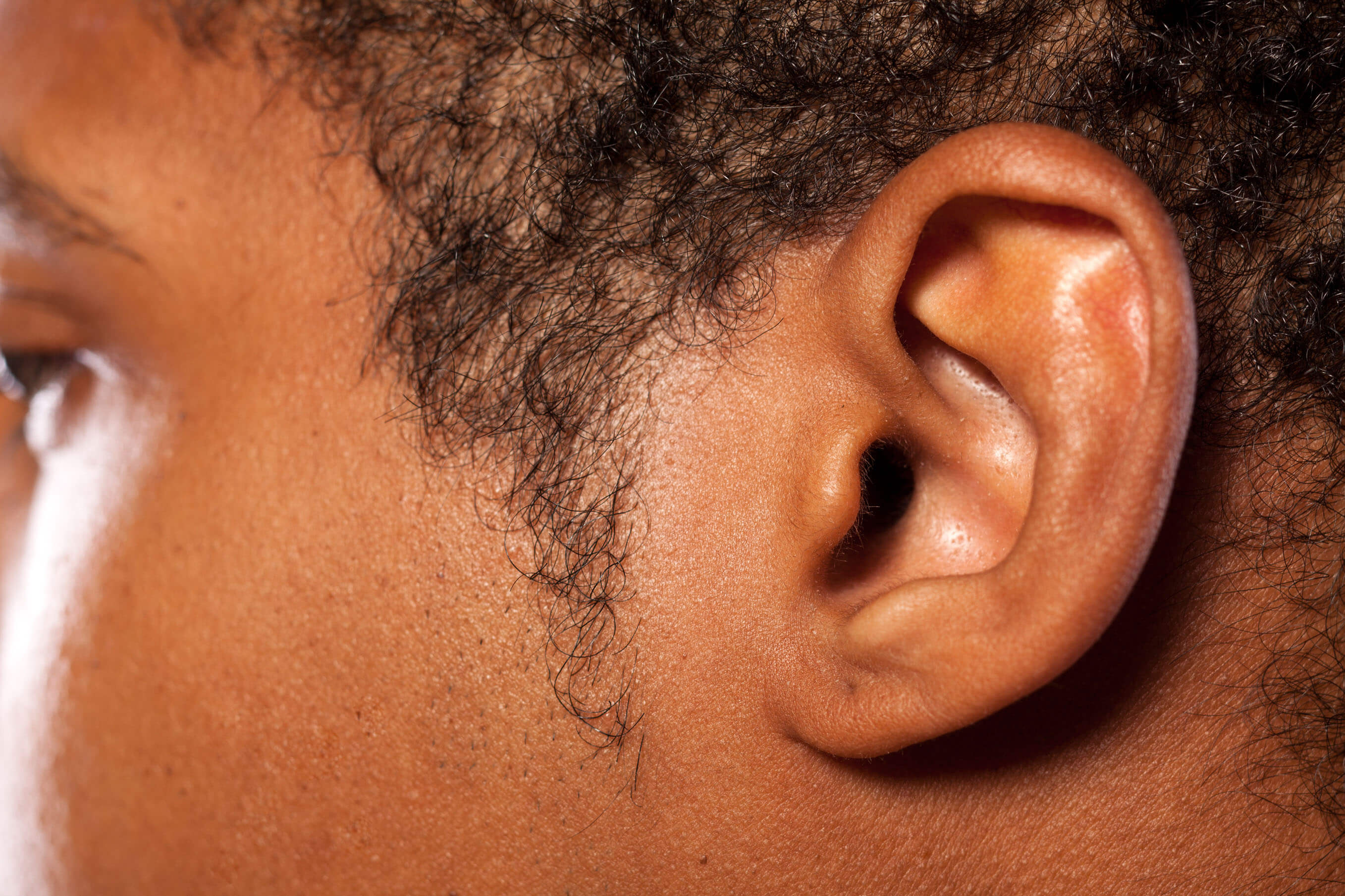 close up shot of the ear of a dark-skinned young man