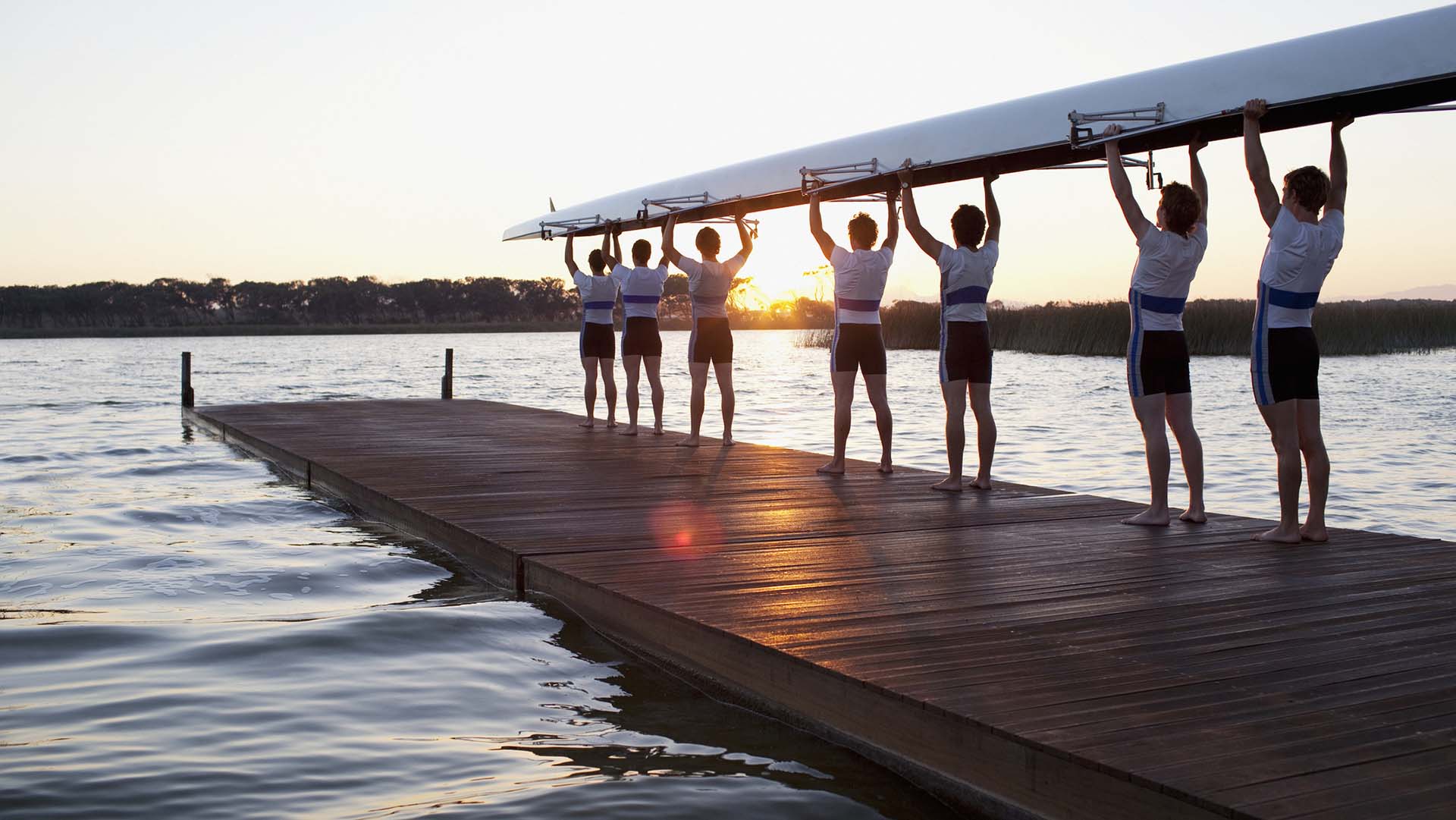 Men holding canoe over heads