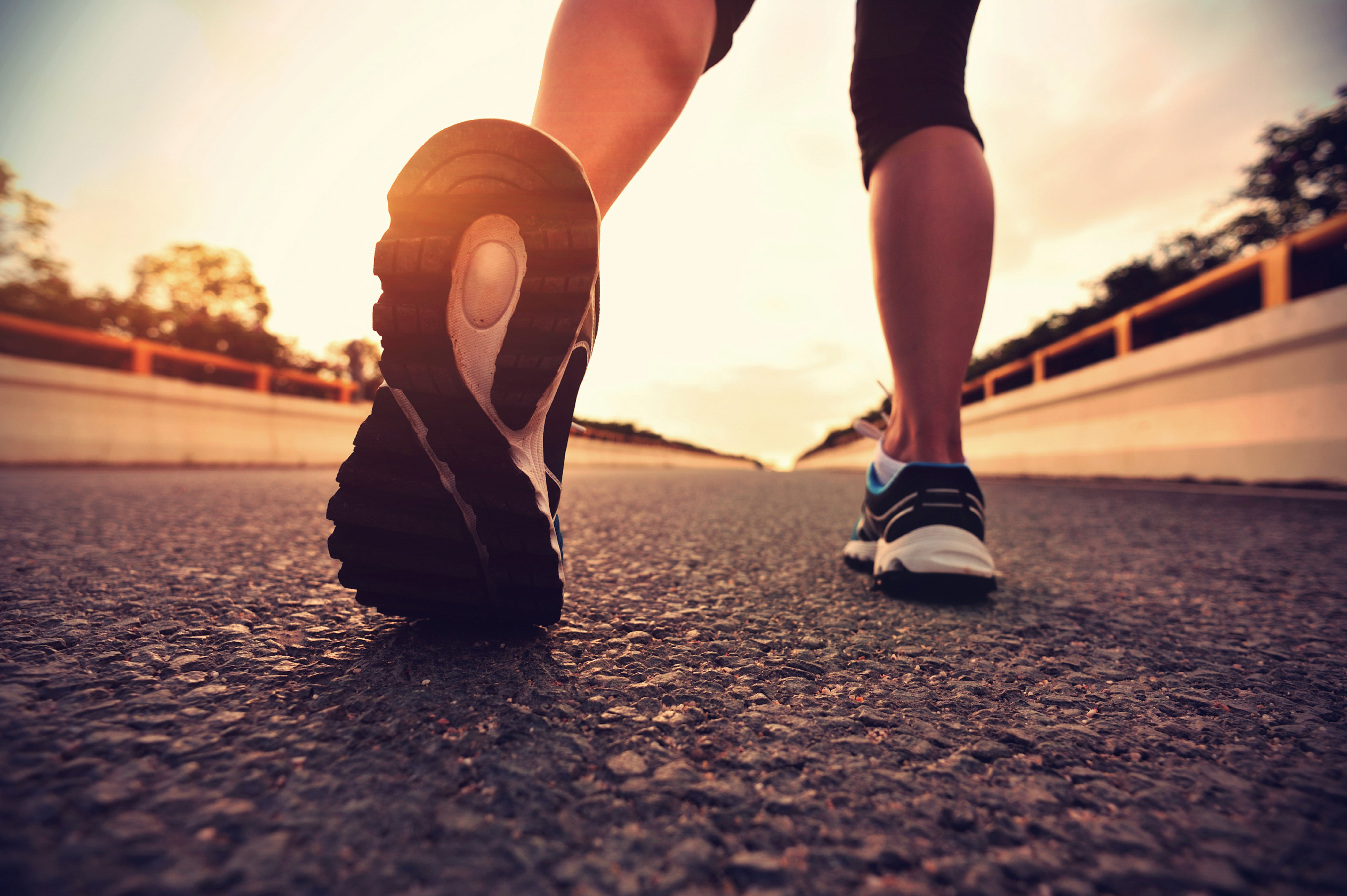 young fitness asian woman runner legs running on road