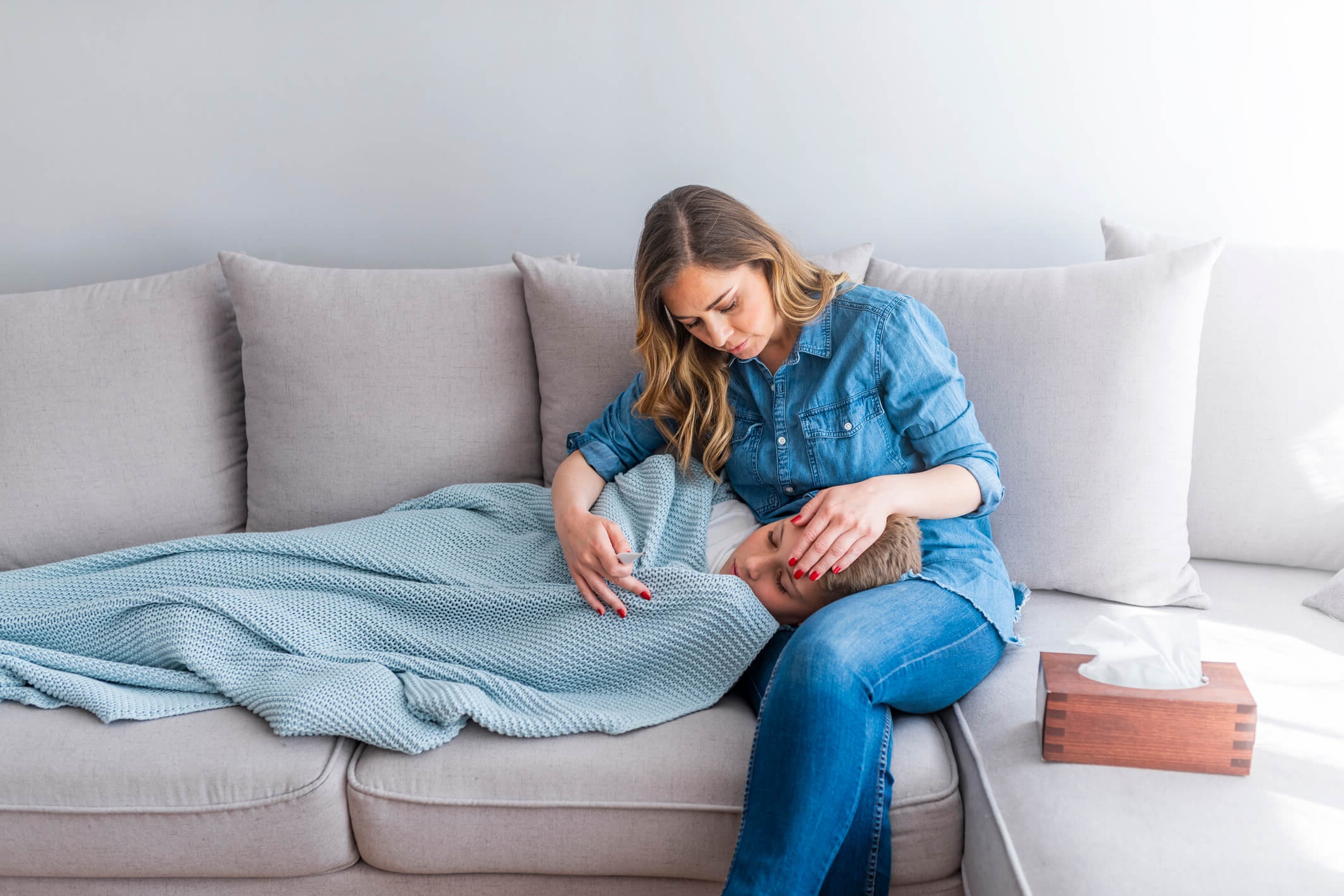 Woman with head of sick child on her lap