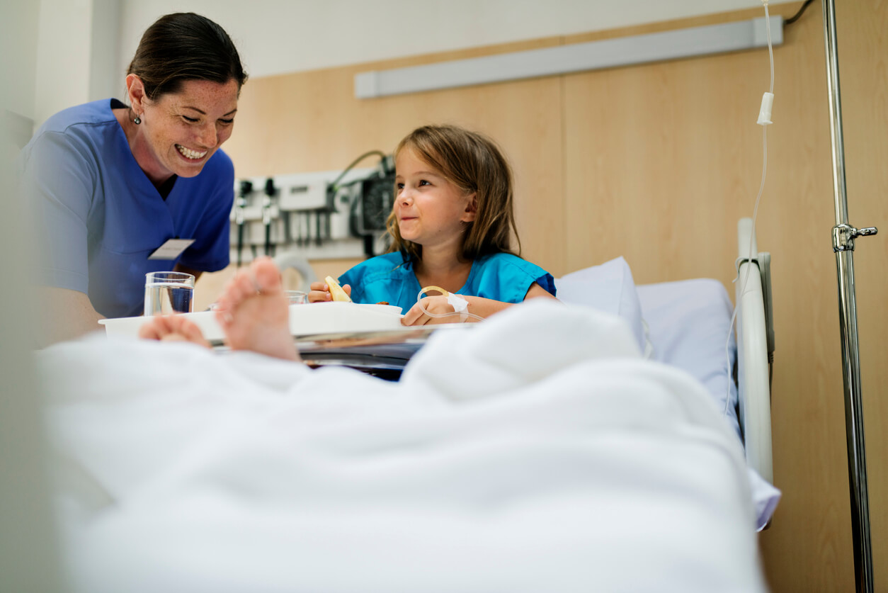 A child in hospital with a health professional