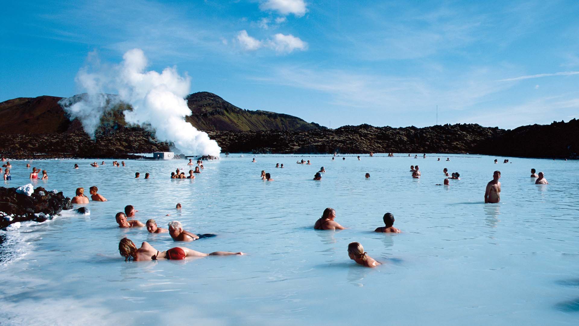 Reykjavik, Iceland - November 11, 2011: People bathing in The Blue Lagoon, a natural hot spring in the south of Iceland. Outdoors, with clear sky.