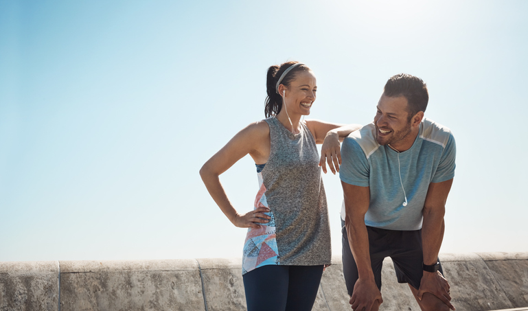 Cropped shot of a young couple out for a run on the promenade