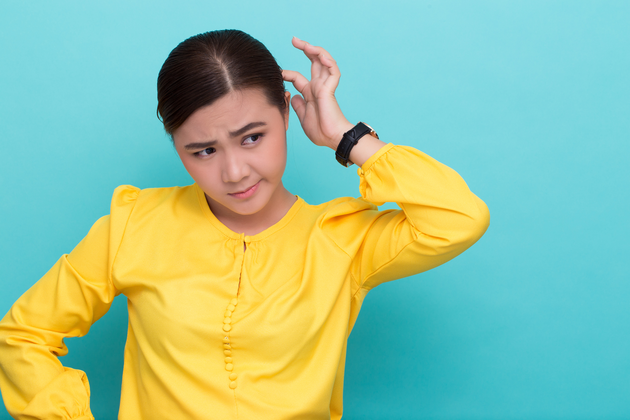 Woman scratching her head